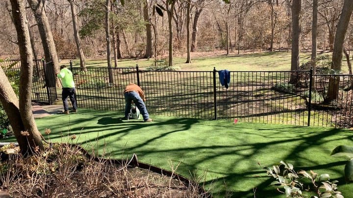 Crew installing artificial turf