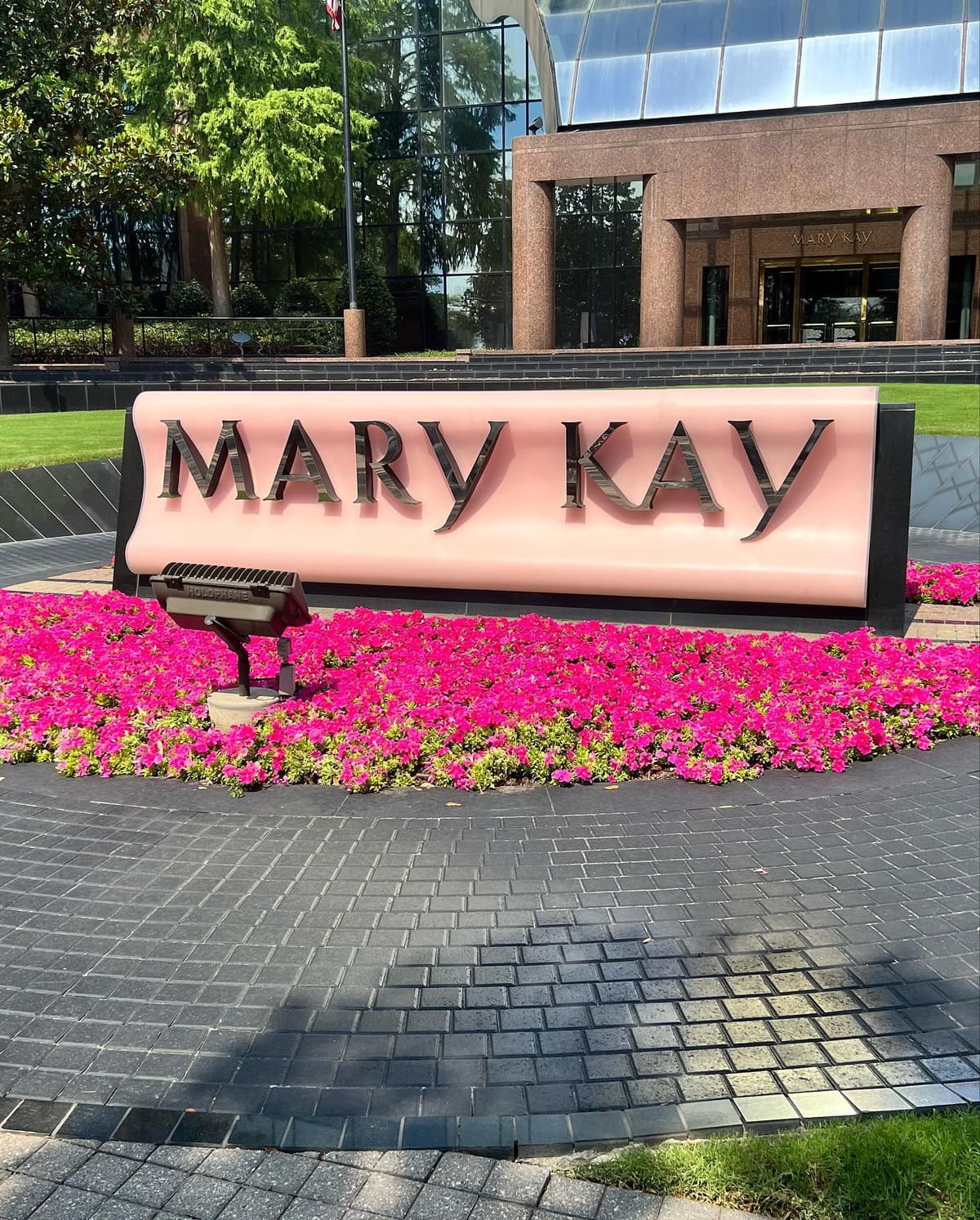 Seasonal color planting at a corporate campus entrance sign