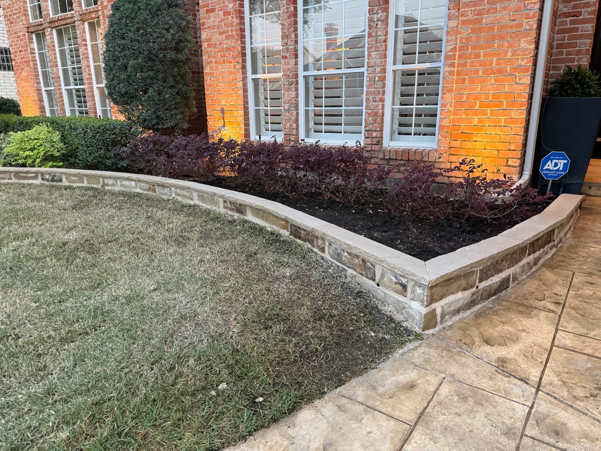 Front bed red shrubs stone edge