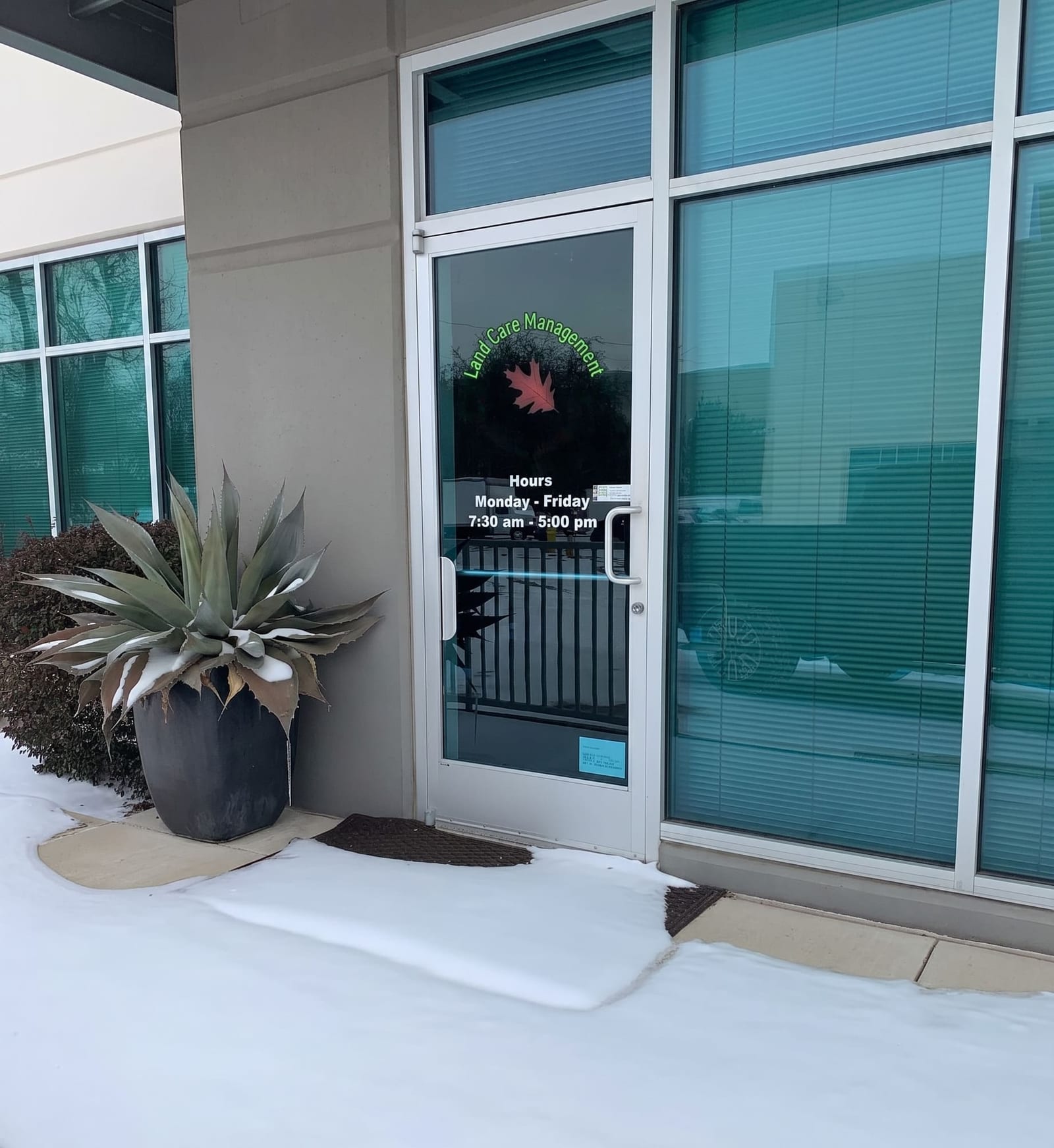 Land Care Management office entrance with an agave planter