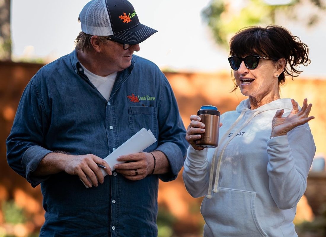 A Land Care team member reviewing a property plan with a client