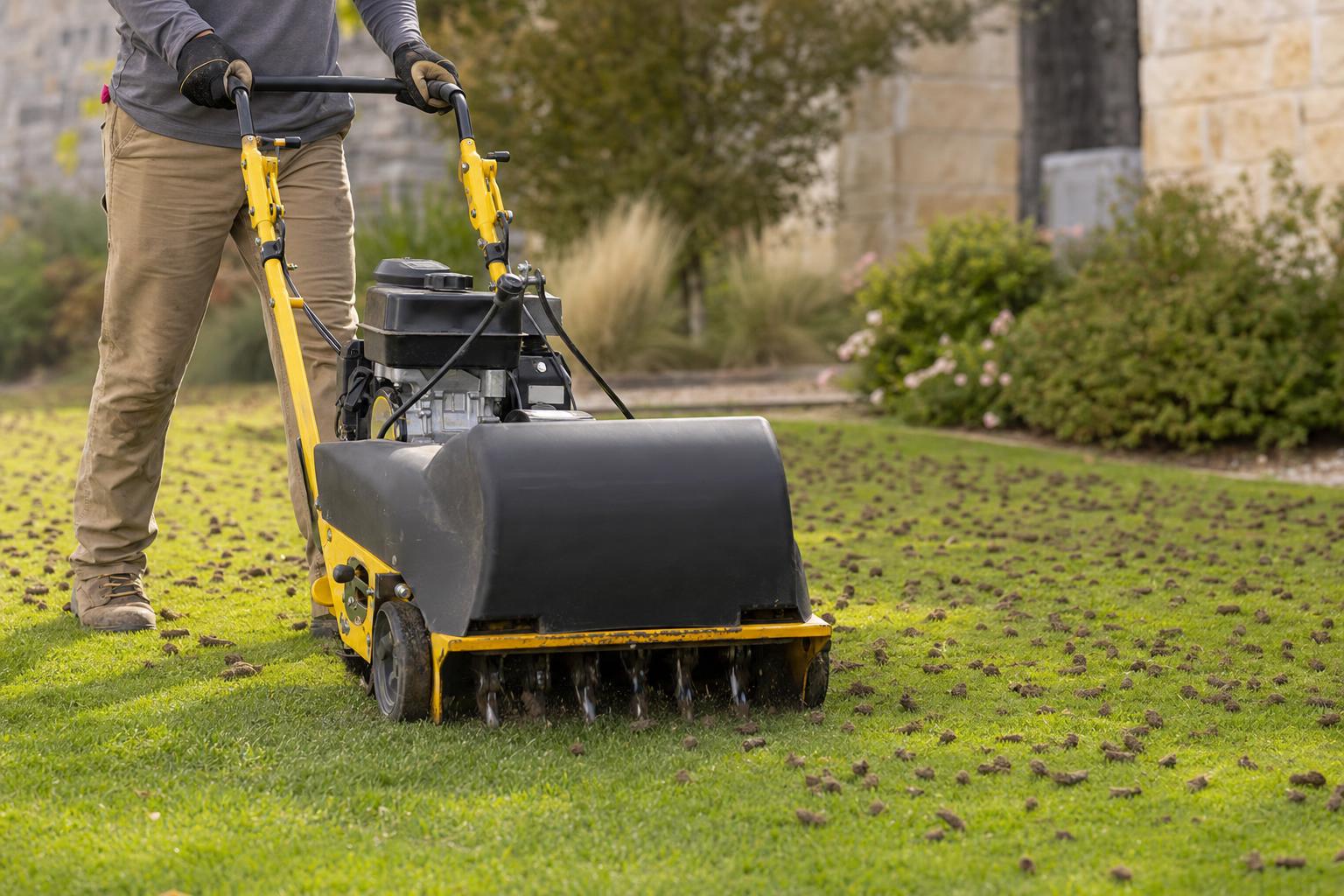 Core aerator pulling soil plugs across a commercial lawn